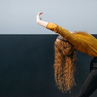 A graceful stretching movement in a bright, open space.