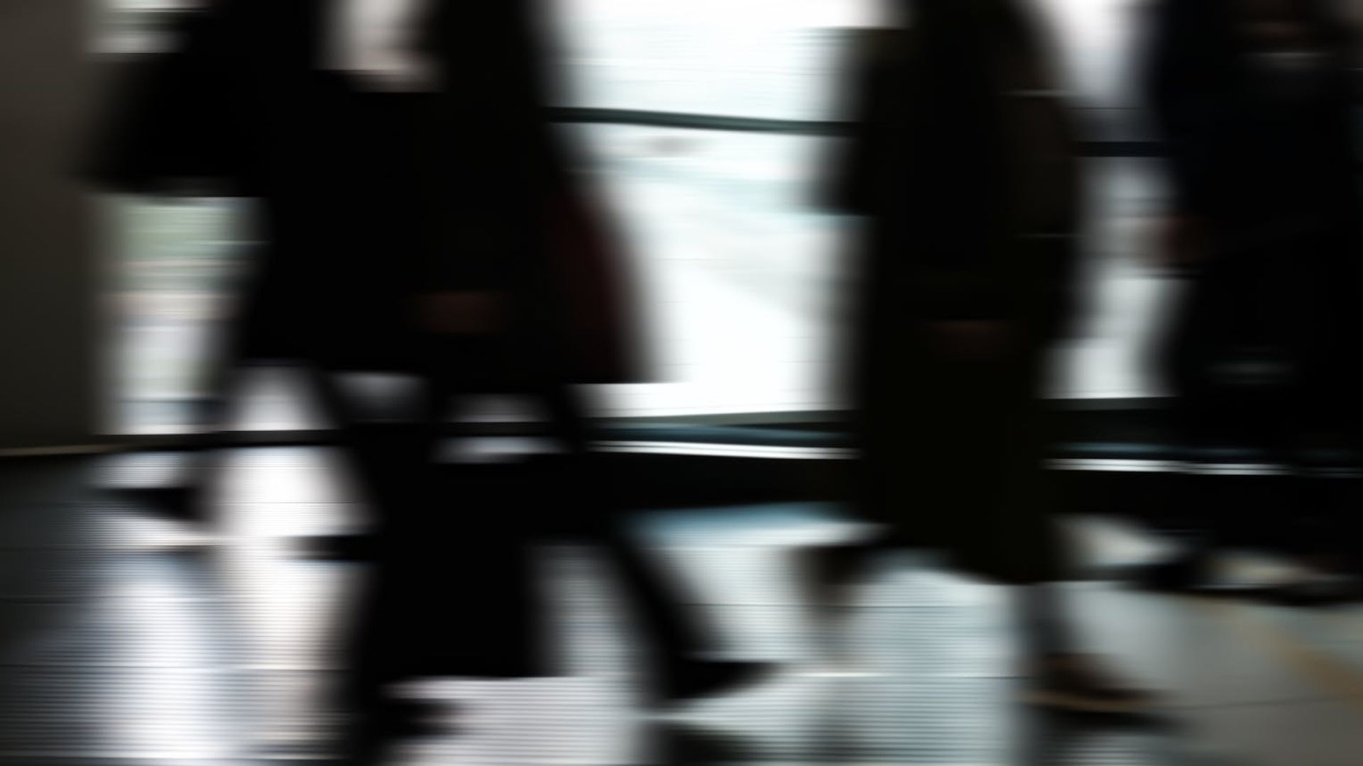 Abstract silhouette of a person in motion against a dark background.